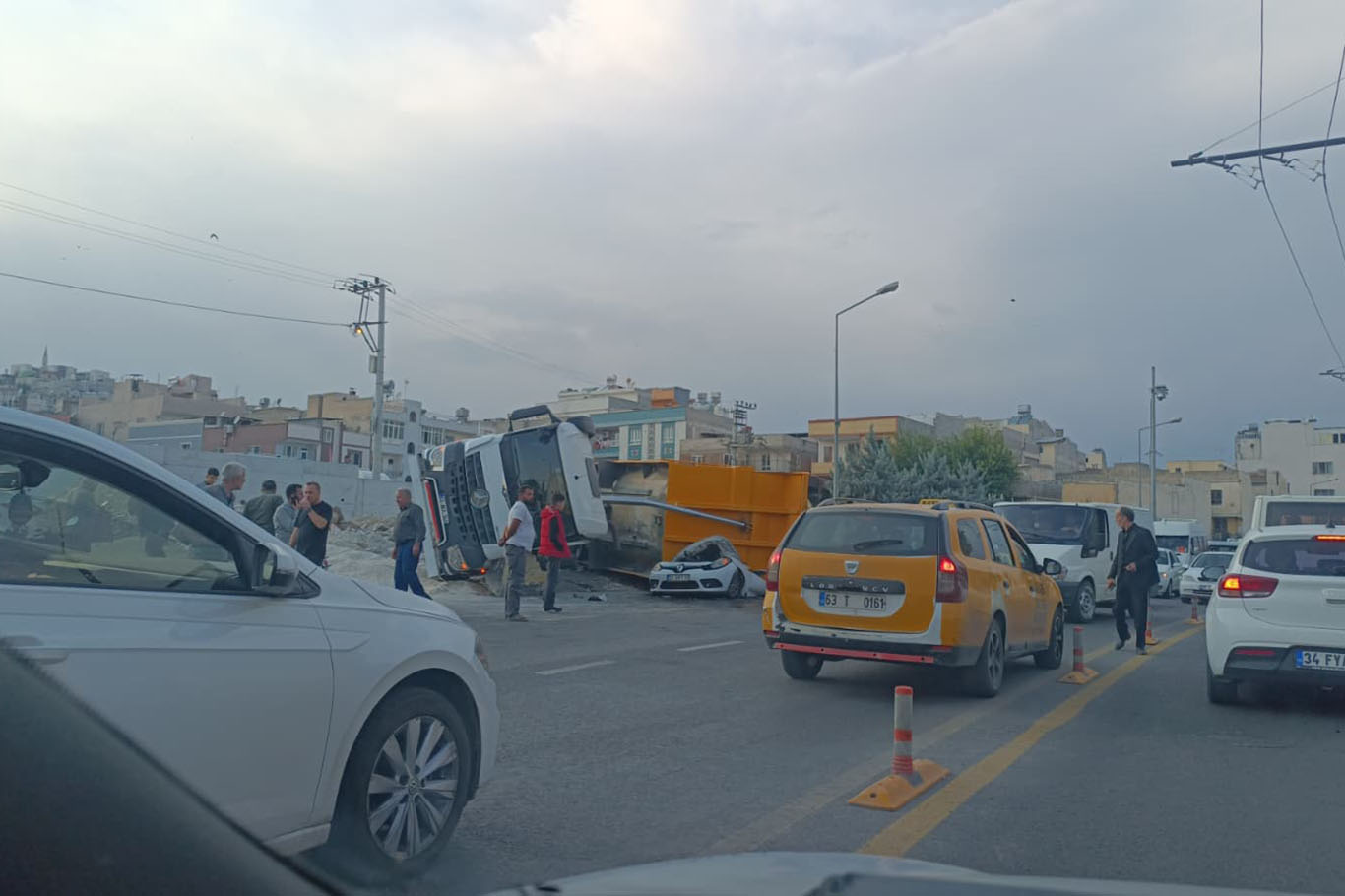 Şanlıurfa'da hafriyat kamyonu park halindeki otomobilin üzerine devrildi